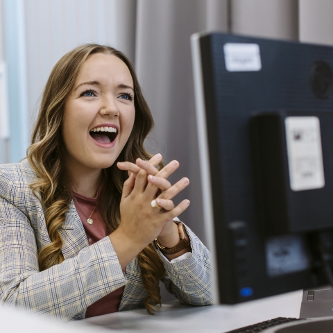 Girl at computer smiling