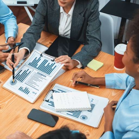 people at table looking at chart