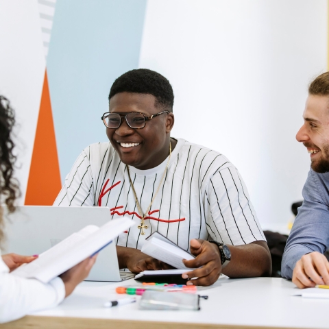 Students studying together in a group smiling and enjoying themselves