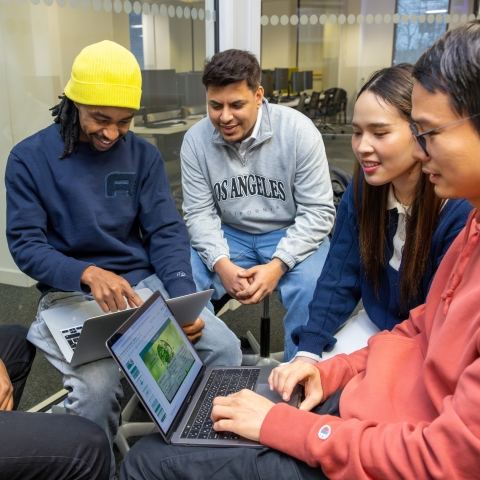 students around laptop