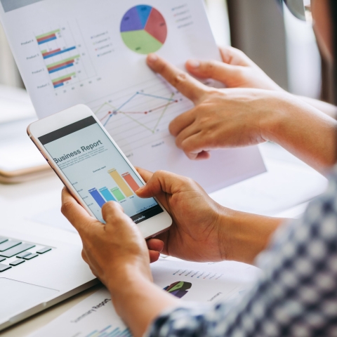 Close up of people looking at graphs