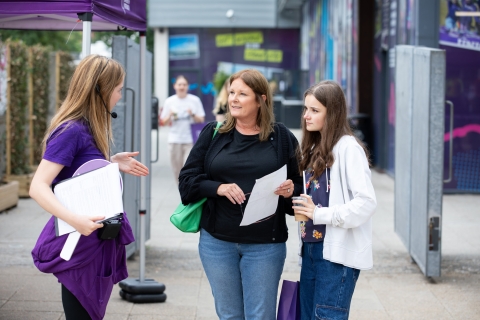 Student ambassador helping family with questions - Open Day 2023