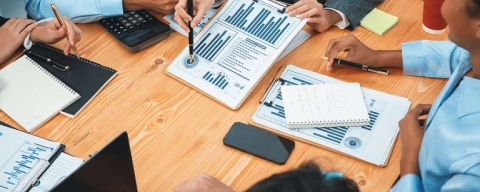 people at table looking at chart