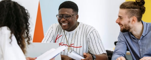 Students studying together in a group smiling and enjoying themselves