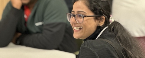 Student smiling in classroom other student smiling in background