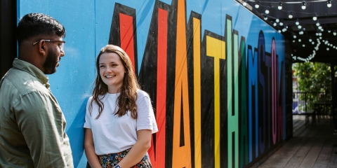 girl and boy in front of sign