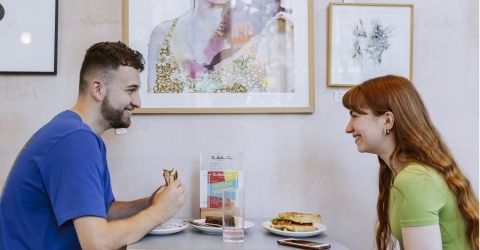 boy and girl with food in cafe
